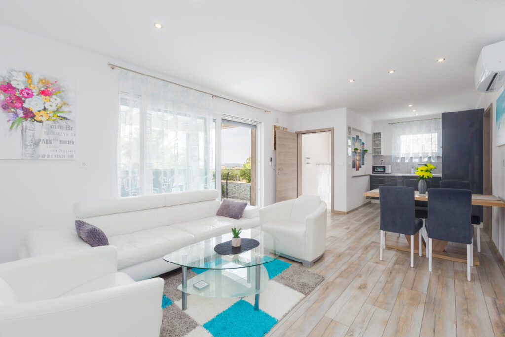 Living room and the look towards the terrace and the entrance of the 1st floor of the villa.