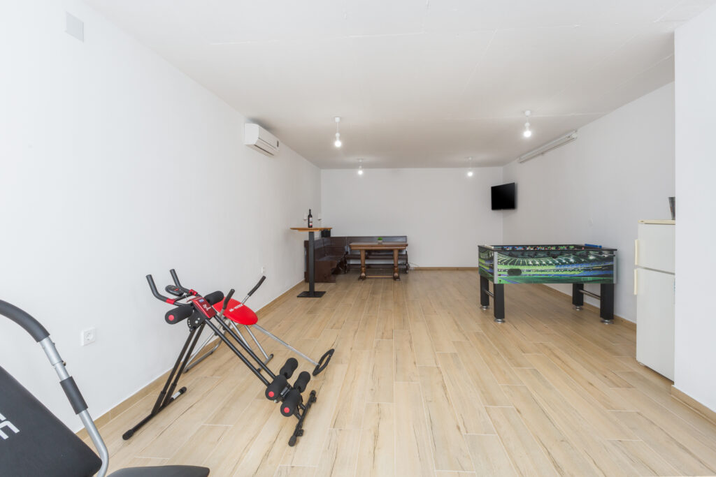 Lower level with workout equipment.